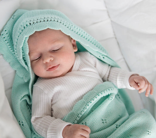 Baby in a mint cellular bamboo baby blanket