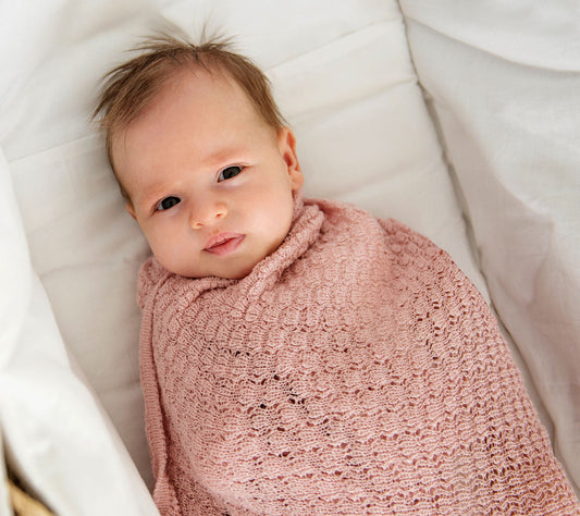 Baby girl in a merino swaddle