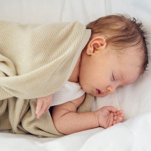 Baby in a light bamboo baby blanket