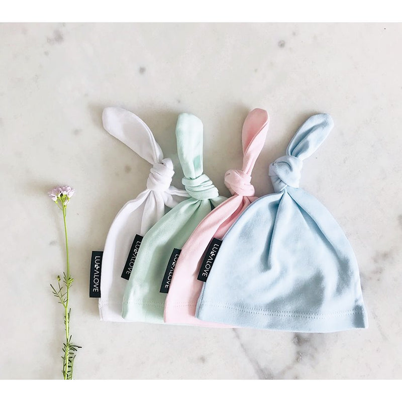 Baby cotton hats in pastel colours