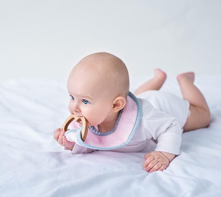 Baby with a wooden teether