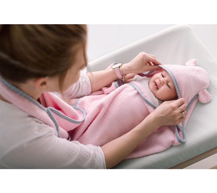 Baby in a pink baby towel with a hood