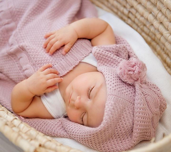 Baby sleeping in moses basket