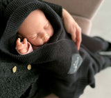 Baby in Lullalove bamboo baby blanket in black